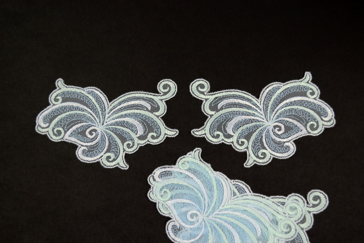 Embroidered appliques in light blue pairs
